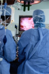Surgeons viewing surgical procedure in theatre.