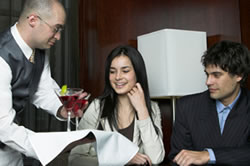 waiter-serving-food-to-a-young-couple